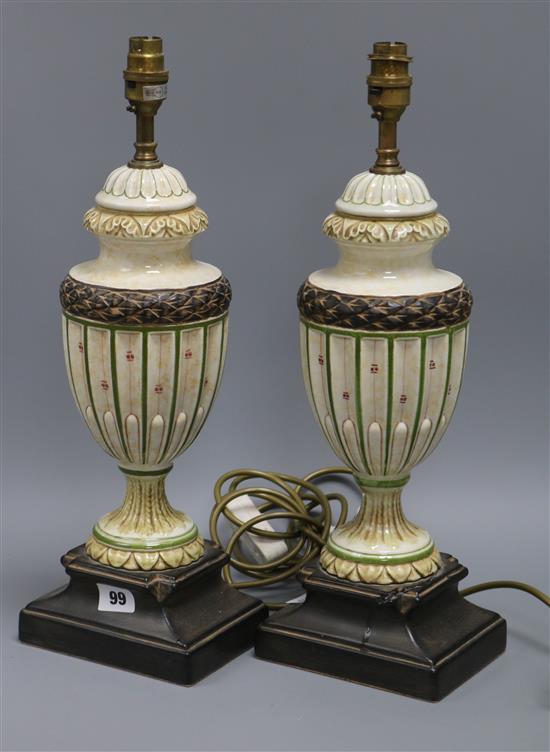 A pair of cream and green urn shaped table lamps